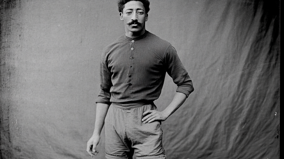 A studio portrait of an black soccer player late 1800s